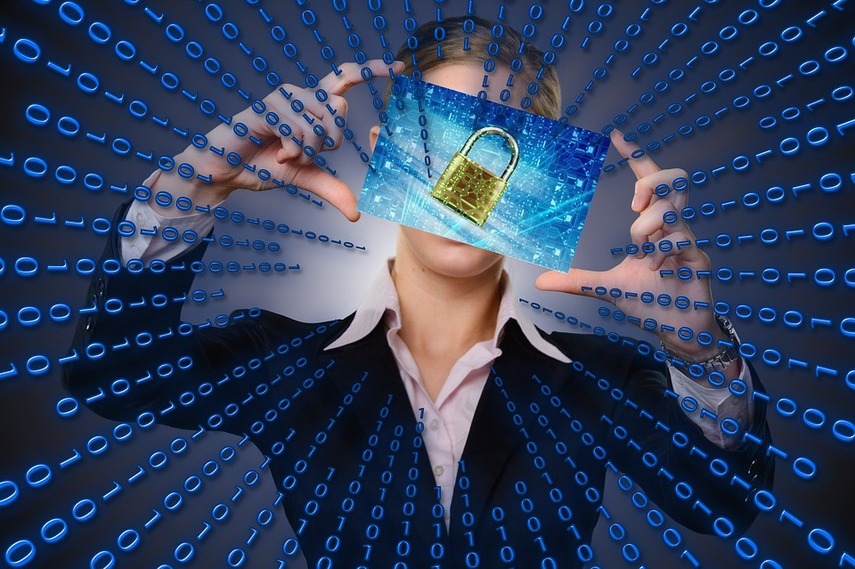 binary code leading to a padlock image being held up by a business woman